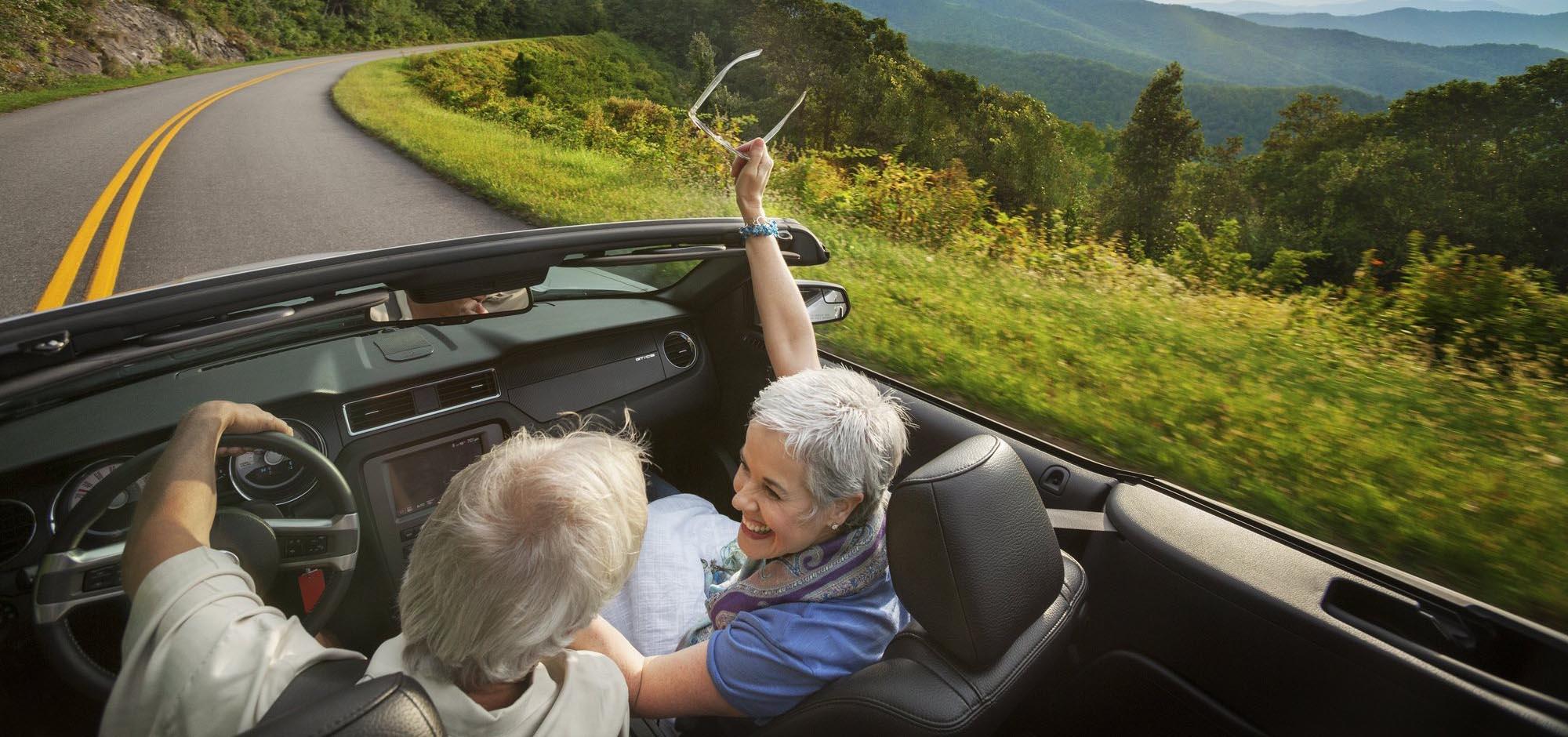 Couple in convertible on road in Asheville