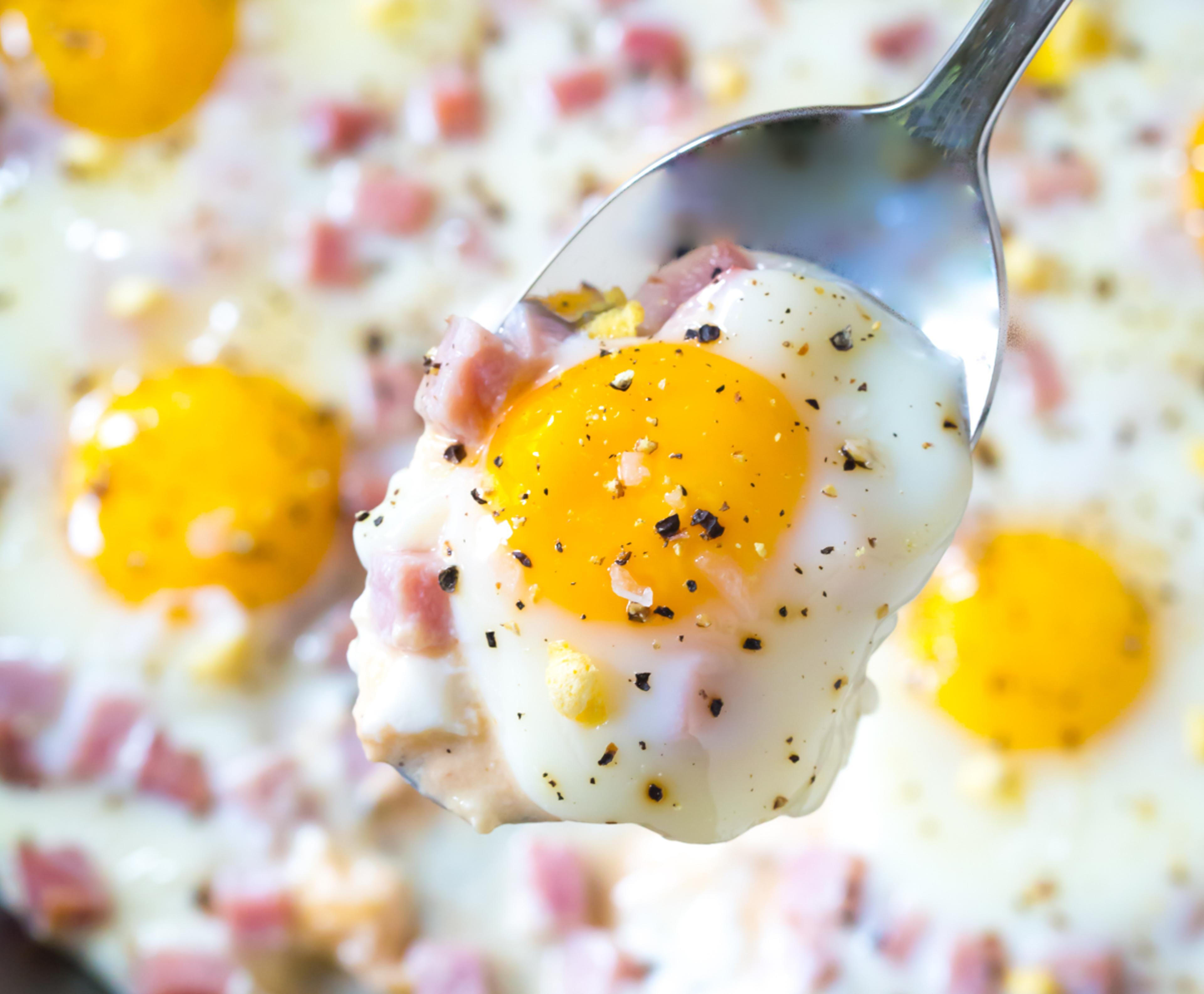 baked eggs with bright-yellow yolks sprinkled with ham