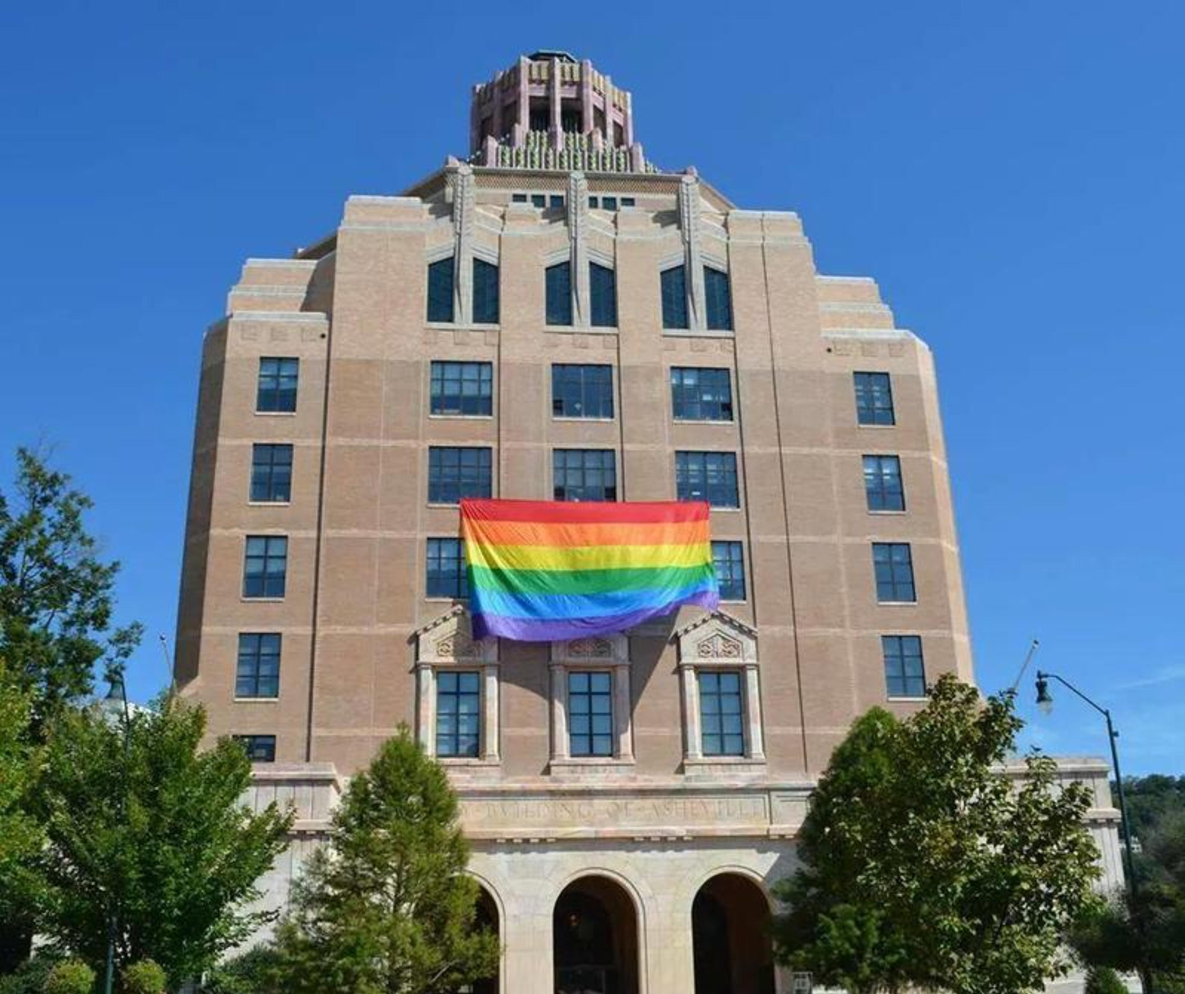 A building in Asheville has a pride flag on the front